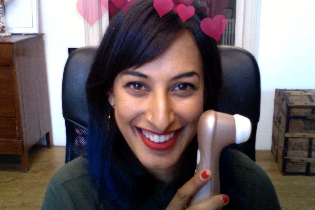 Kali Sudhra holding a sex toy in the Erika Lust Films office